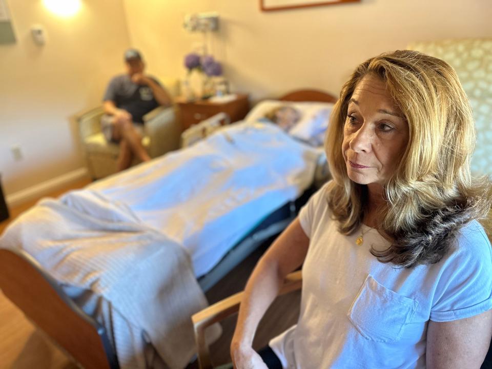 Elizabeth Ruest, right, keeps vigil for her mom, Annemarie Minicucci, in the family's room at the HopeHealth hospice building in Providence. Elizabeth's brother Steve Minicucci is in the background.