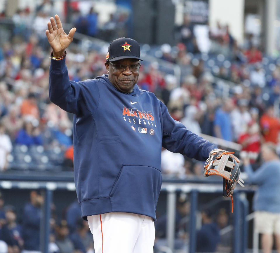 Houston Astros manager Dusty Baker Jr. waves to the crowd before the team's spring training baseball game against the Washington Nationals in West Palm Beach, Fla., Saturday, Feb. 22, 2020. (Karen Warren/Houston Chronicle via AP)