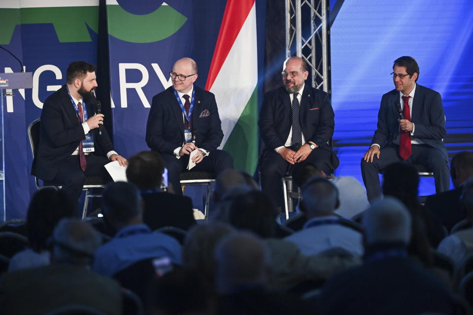 From left, Istvan Kovacs, Strategic Director of the Center for Fundamental Rights, Jerzy Kwasniewszky, President of the Polish Catholic organisation and think tank Ordo Iuris, Alvino-Mario Fantini, Editor-in-Chief of the Italian bi-annual publication The European Conservative, and Eugene Kontorovich, President of the Israeli think tank Kohelet Policy Forum, attend the CPAC conference in Budapest, Hungary, Thursday, May 19, 2022. Dozens of prominent conservatives from Europe, the United States and elsewhere have gathered in Hungary for the American Conservative Political Action Conference, being held in Europe for the first time. The two-day event represents a deepening of ties between the American right wing and the autocratic government of Prime Minister Viktor Orban. (Tibor Illyes/MTI via AP)