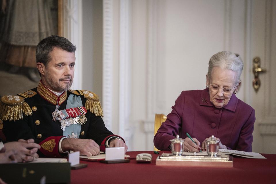 Denmark's Queen Margrethe II signs a declaration of abdication in the Council of State meeting, at Christiansborg Castle in Copenhagen, Sunday, Jan. 14, 2024. Queen Margrethe II has signed her historic abdication, paving the way for her son Frederik X to immediately become king. (Mads Claus Rasmussen/Ritzau Scanpix via AP)