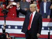 President Donald Trump waves to the crowd during a rally Wednesday, Oct. 31, 2018, in Estero, Fla. (AP Photo/Chris O'Meara)