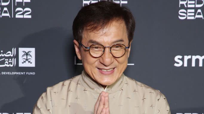 jackie chan smiling for a photograph at the red sea film festival