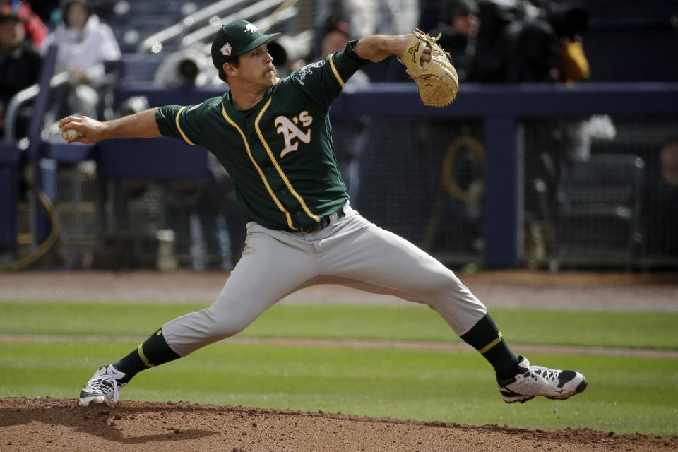 Oakland Athletics starting pitcher Daniel Mengden throws during the first inning of a spring training baseball game against the Seattle Mariners, Friday, Feb. 22, 2019, in Peoria, Ariz. (AP Photo/Charlie Riedel)