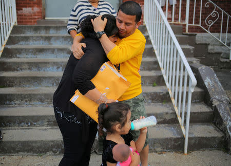 A woman from El Salvador, requesting to be identified only as "E" for her family's safety, is embraced by a family friend before leaving Vive La Casa shelter by taxi with her daughters to file a refugee claim at the Canadian border, in Buffalo, New York. REUTERS/Chris Helgren