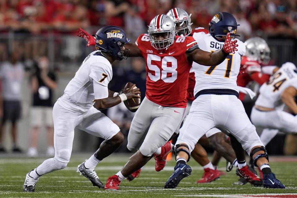 Sep 17, 2022; Columbus, Ohio, USA; Ohio State Buckeyes defensive tackle Ty Hamilton (58) pursues Toledo Rockets quarterback Dequan Finn (7) during the first half of the NCAA Division I football game at Ohio Stadium. Mandatory Credit: Adam Cairns-The Columbus Dispatch