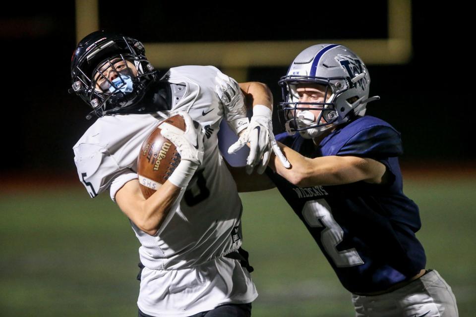 Silverton's Carson Waples (5) is pushed out of bounds by Wilsonville's Kheller Larson (2) in a playoff game on Friday, Nov. 11, 2022, in Wilsonville, Ore.