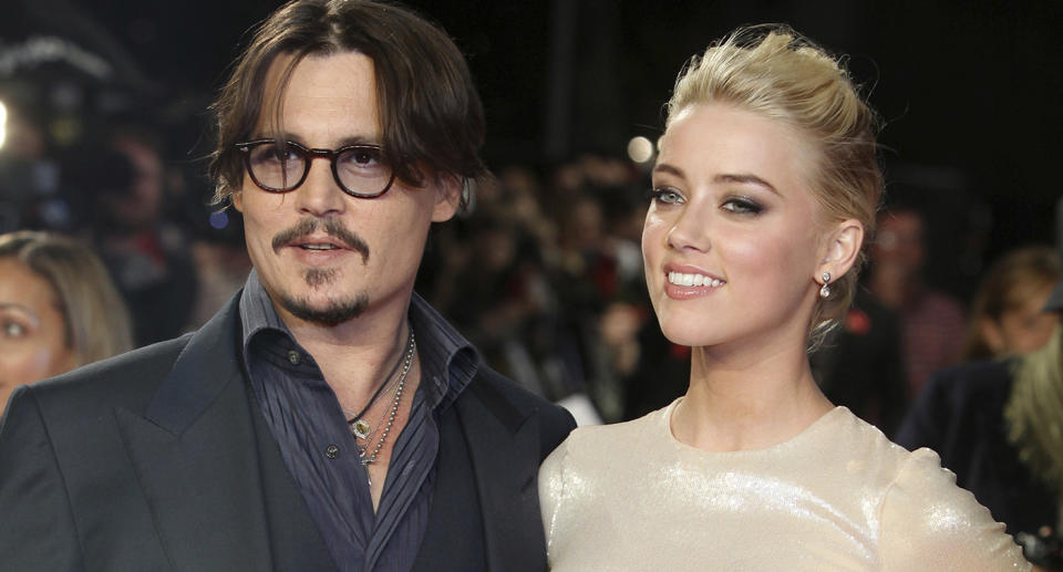 Johnny Depp and Amber Heard pose on the red carpet for a film premiere in 2011.