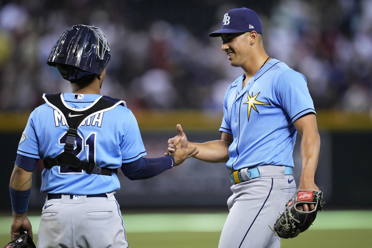 Tampa Bay Rays pitcher Phoenix Sanders, left, throws to first base