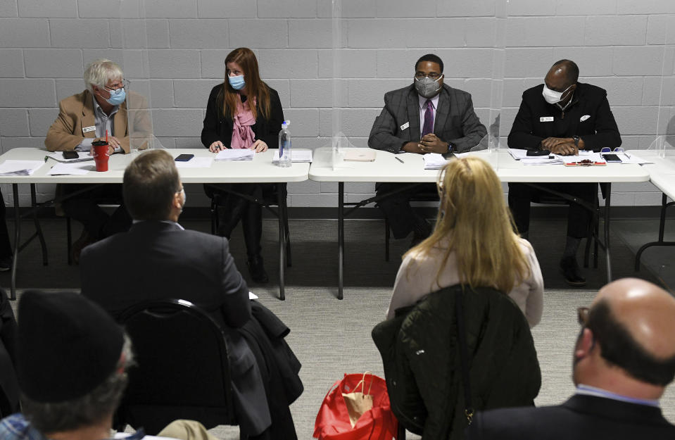 Wayne County Board of Canvassers, from left, Republican member William Hartmann, Republican chairperson Monica Palmer, Democrat vice chair Jonathan Kinloch, and Democratic member Allen Wilson discuss a motion to certify election results during a board meeting in Detroit on Tuesday, Nov. 17, 2020. On Thursday, Nov. 19, 2020, state officials said Wayne County, Michigan's largest county, cannot revoke its certification of election results after two Republicans who approved Democratic candidate Joe Biden's local landslide wanted to revert to their initial stance of refusing to bless the vote tally. State officials said the certification of the Detroit-area vote will stand. (Robin Buckson/Detroit News via AP)