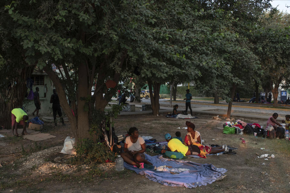 Haitian migrants wake up at an encampment at a sports park in Ciudad Acuna, Mexico, Tuesday, Sept. 21, 2021. U.S. authorities have moved to expel many of the migrants who were camped around a bridge in Del Rio, Texas, after crossing from Ciudad Acuna, Mexico. Officials are also trying to to block others from crossing the border from Mexico. (AP Photo/Felix Marquez)