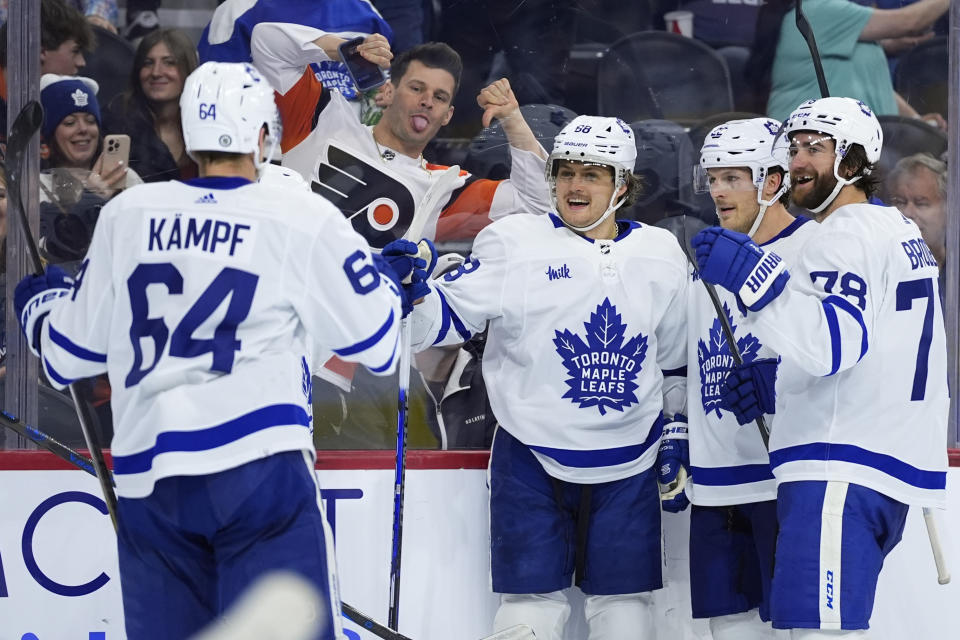 Toronto Maple Leafs' William Nylander (88) celebrates with David Kampf (64), Jake McCabe (22) and TJ Brodie (78) after scoring a goal during the third period of an NHL hockey game against the Philadelphia Flyers, Thursday, March 14, 2024, in Philadelphia. (AP Photo/Matt Slocum)