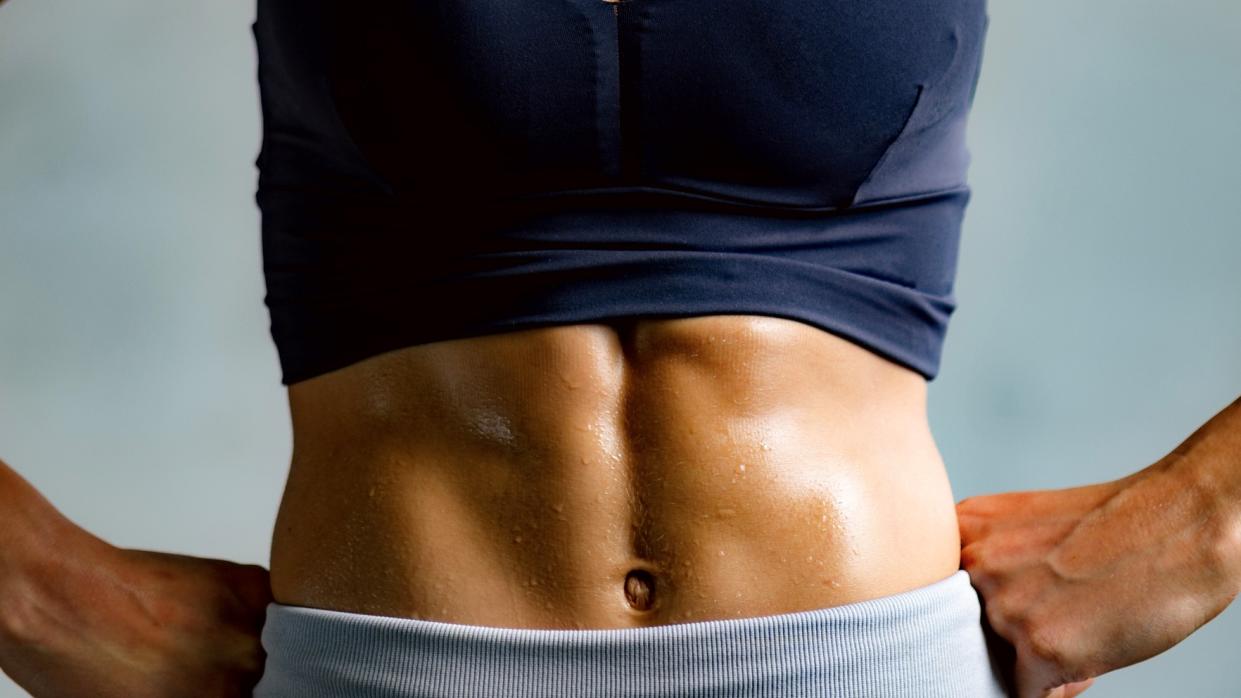  A photo of a woman with strong abs. 