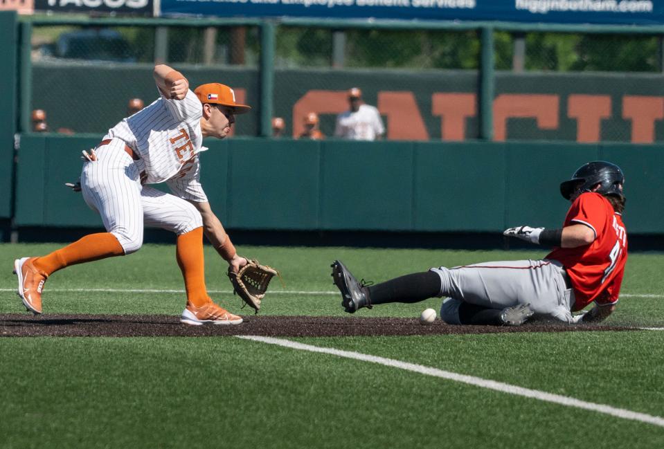 Infielder Jack O'Dowd (27) attempts to tag out Texas Tech’s Nolen Hester (41) during a game at UFCU Disch-Falk Field against Texas Tech on Saturday, March 25, 2023. 