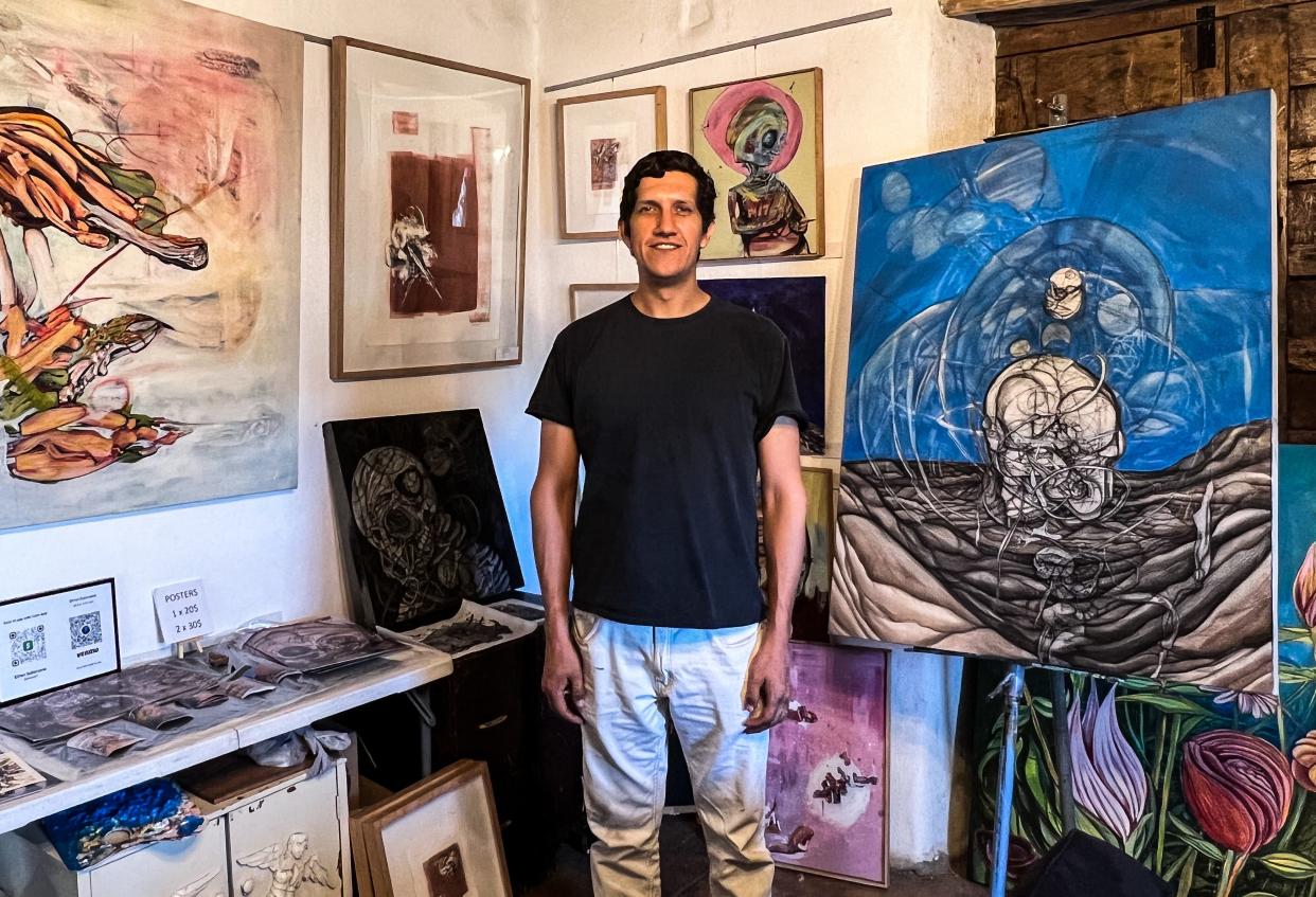 El Paso artist Efrén Solórzano stands among a collection of his works in his studio space at Casa Ortiz. His exhibit, "A.M.O.K. + Retrospectiva," will run through June 2022 at Casa Ortiz.