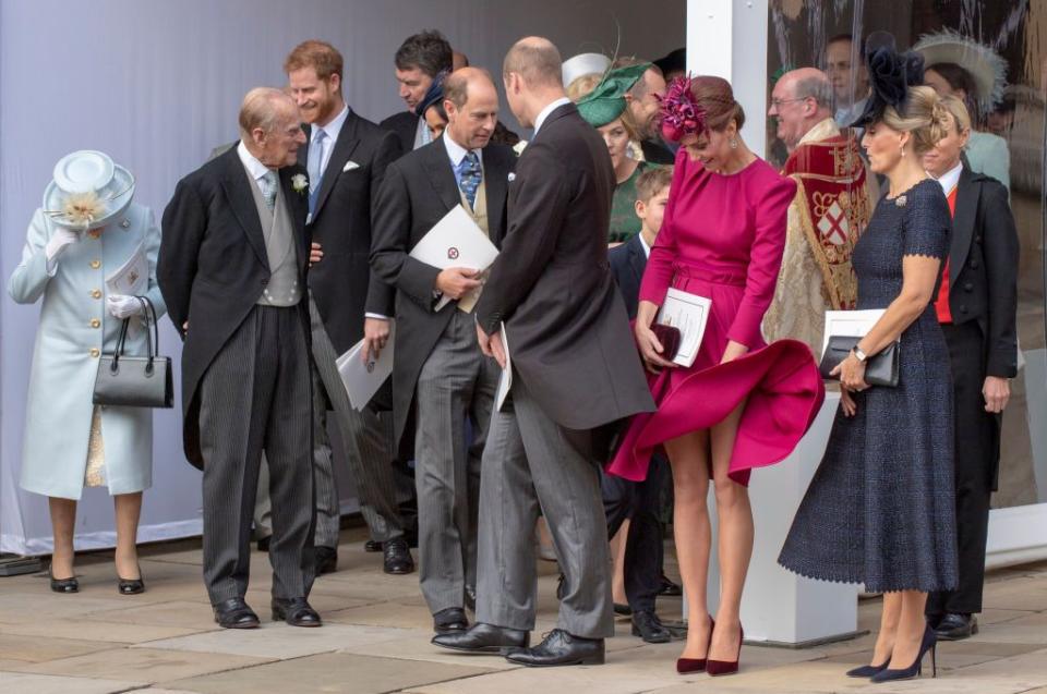 The royal family gathers to see them off on their carriage ride.