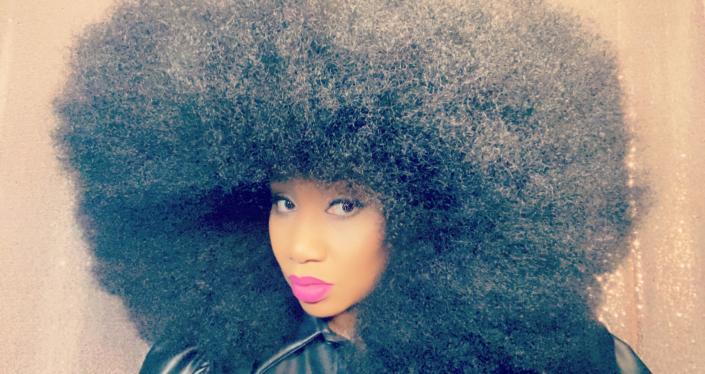 Aevin Dugas, a Louisiana native who has an afro measuring&nbsp;9.84 inches tall, 10.24 inches&nbsp;wide and 5.41 feet&nbsp;in circumference. Her hair set a Guinness world record for the biggest afro among women.