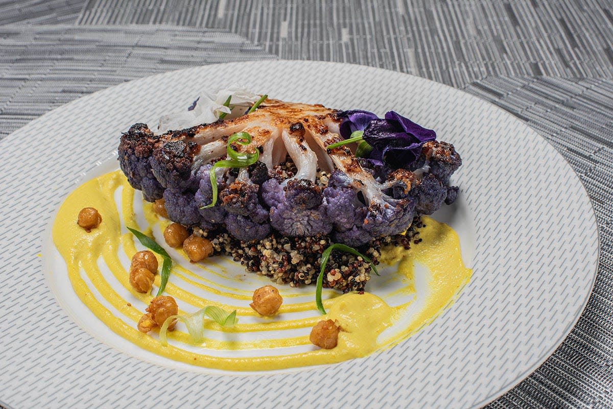 A pan-seared purple cauliflower steak is among executive chef Bernard Beronio’s creations for the Savour on Broadway menu at the Mulva Cultural Center in De Pere.