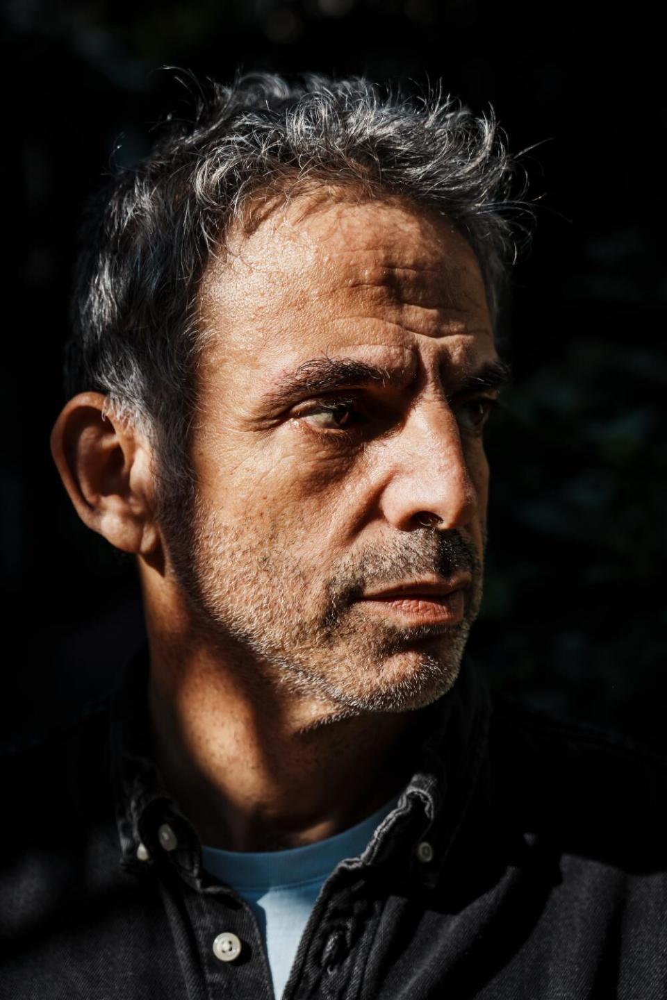 Etgar Keret poses for portrait outside his home in Tel Aviv.