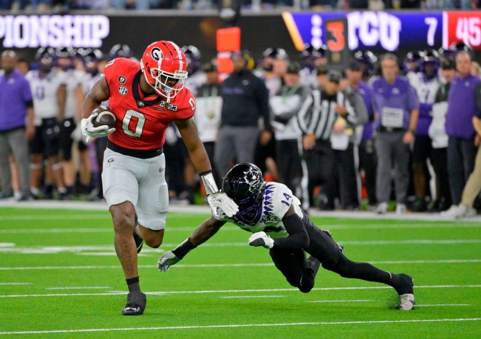 Jan 9, 2023; Inglewood, CA, USA; Georgia Bulldogs tight end Darnell Washington (0) runs the ball against TCU Horned Frogs safety Abraham Camara (14) during the second half in the CFP national championship game at SoFi Stadium. Mandatory Credit: Jayne Kamin-Oncea-USA TODAY Sports