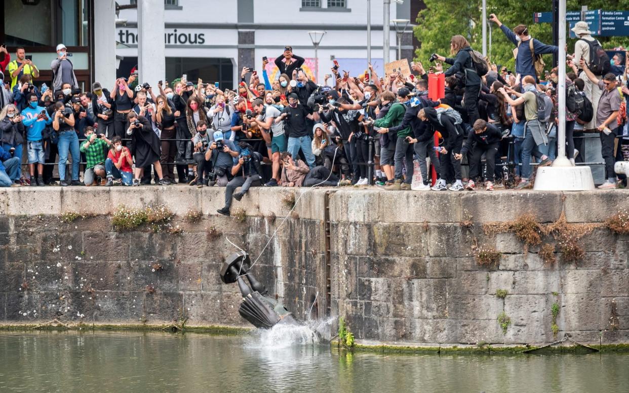 Protesters throw the statue of Edward Colston into Bristol harbour during a Black Lives Matter protest rally - Keri Gravel/Reuters