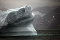 FILE- In this July 26, 2011 photo, a melting iceberg floats along a fjord leading away from the edge of the Greenland ice sheet near Nuuk, Greenland. The COP 24 UN Climate Change Conference is taking place in Katowice, Poland. Negotiators from around the world are meeting for talks on curbing climate change. (AP Photo/Brennan Linsley, File)