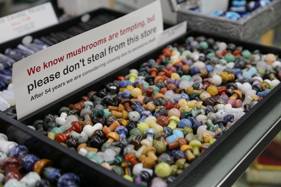 A container of mushroom stones with a "please don't steal from this store" sign on it at Von's shop, on Thursday, Mar. 9, 2023, in West Lafayette, Ind.