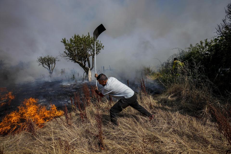 FILE - A local resident fights a forest fire with a shovel during a wildfire in Tabara, north-west Spain, July 19, 2022. Spain suffered the biggest losses from wildfires of any European Union country last year amid a record-hot 2022. (AP Photo/Bernat Armangue, File)