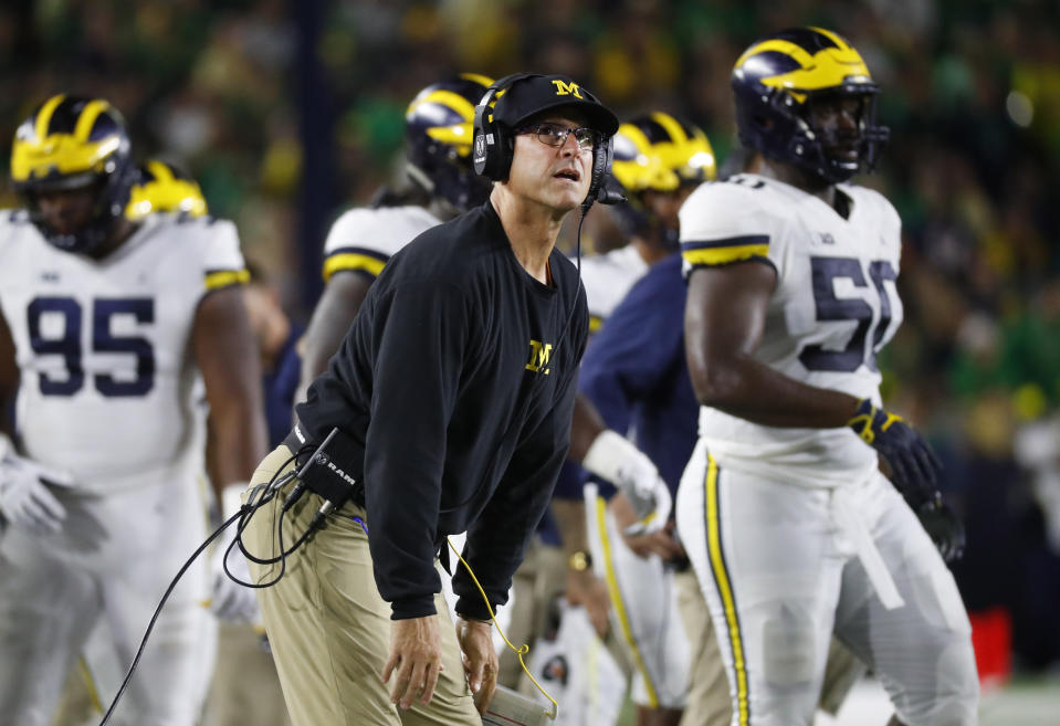 Michigan head coach Jim Harbaugh watches a replay in the first half of an NCAA football game against Notre Dame in South Bend, Ind., Saturday, Sept. 1, 2018. (AP Photo/Paul Sancya)
