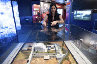 Deputy Director for the Museum in the Central Intelligence Agency Janelle Neises describes a model of the compound where U.S. forces located and killed Osama bin Laden in Abbottabad, Pakistan, that is on display in the refurbished museum in the CIA headquarters building in Langley, Va., on Saturday, Sept. 24, 2022. (AP Photo/Kevin Wolf)