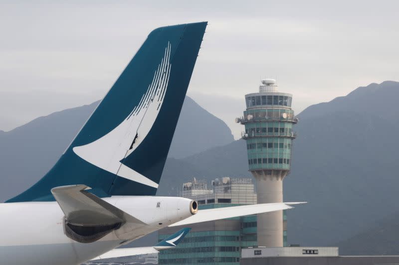 FILE PHOTO: A Cathay Pacific jet is seen in front of air traffic control tower at the Hong Kong International Airport, Hong Kong