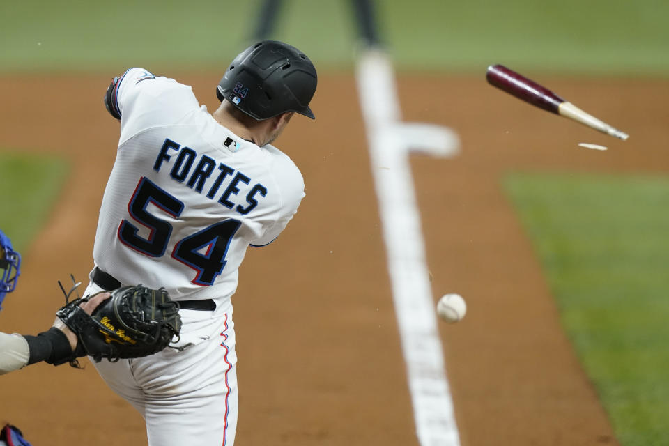 Miami Marlins' Nick Fortes (54) breaks his bat and singles to load the bases during the third inning of a baseball game against the Chicago Cubs, Monday, Sept. 19, 2022, in Miami. (AP Photo/Lynne Sladky)