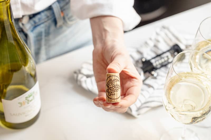 Someone holding wine cork.