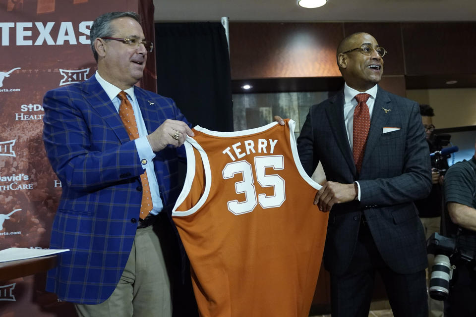 New Texas NCAA college basketball head coach Rodney Terry, right, poses for a photo with Texas Athletic Director Chris Del Contem during a news conference in Austin, Texas, Tuesday, March 28, 2023. (AP Photo/Eric Gay)