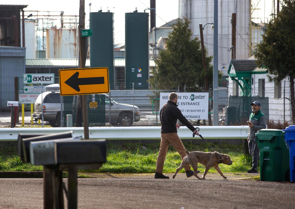 Neighbors meet along a pedestrian path near the J.H. Baxter & Co. plant in Eugene.