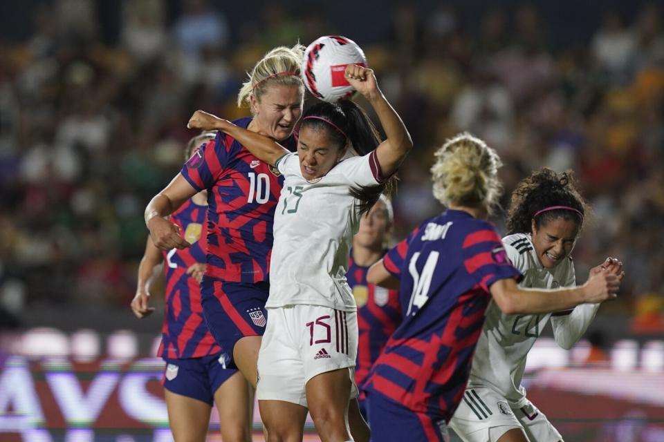 Mexico's Cristina Ferral and the United States' Lindsey Horan fight for the ball.