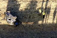 Emergency responders investigate the scene of a crash, Thursday, Feb. 22, 2024 on U.S. 287 about 10 miles (16 kilometers) south of the Wyoming-Colorado line between Laramie and Fort Collins, Colo. Three members of the University of Wyoming swimming and diving team were killed in the crash. (KMGH Denver7 via AP)