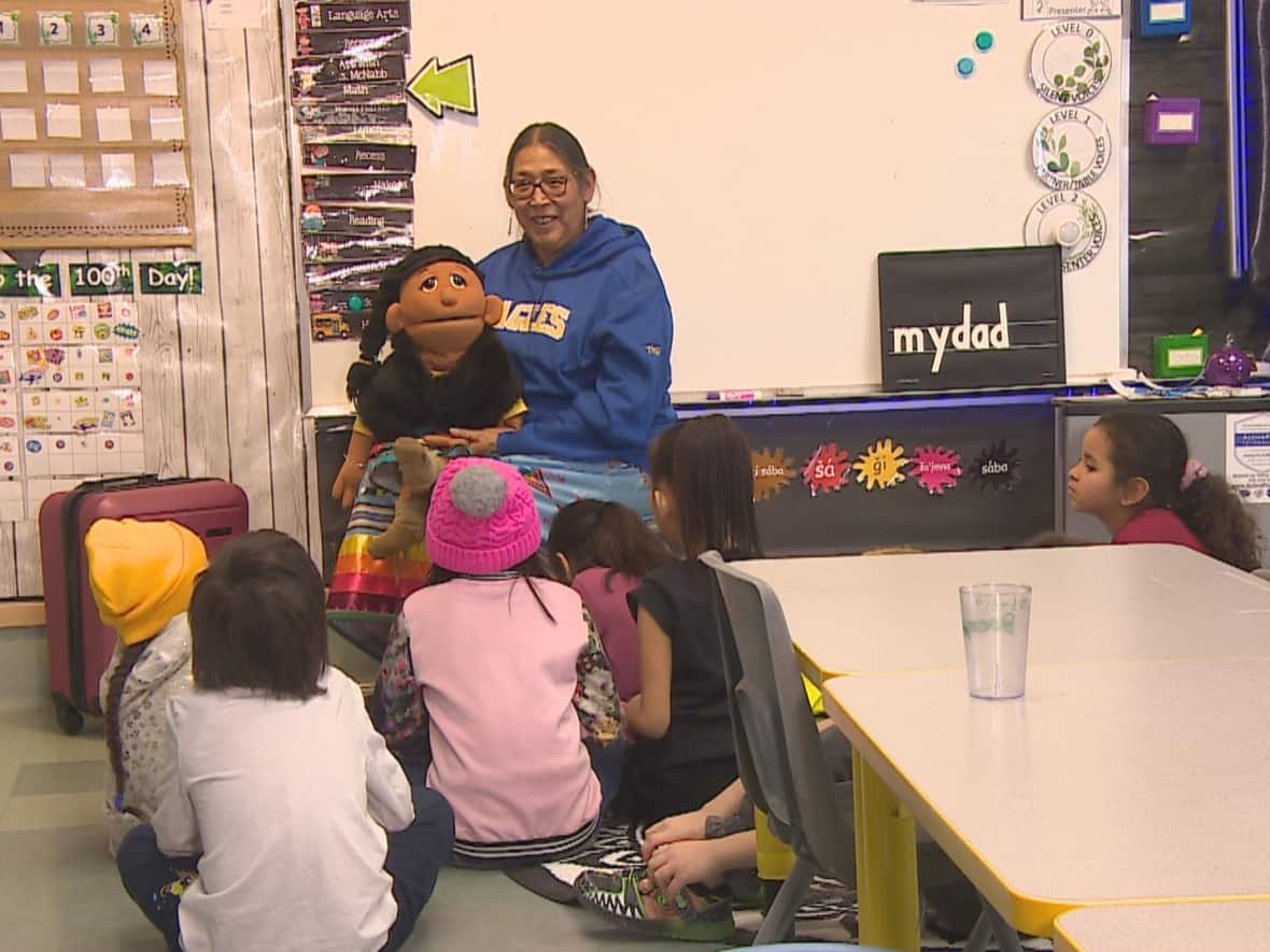 Theresa O'Watch teaches a Nakoda language class with the help of Kushi, a puppet gifted to her by a friend. (Richard Agecoutay/CBC - image credit)