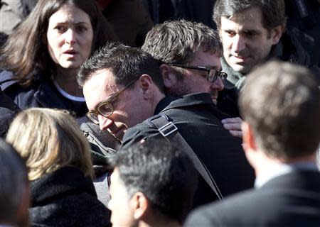 People hug following the funeral of Philip Seymour Hoffman at St. Ignatius church in the Manhattan borough of New York February 7, 2014. REUTERS/Carlo Allegri