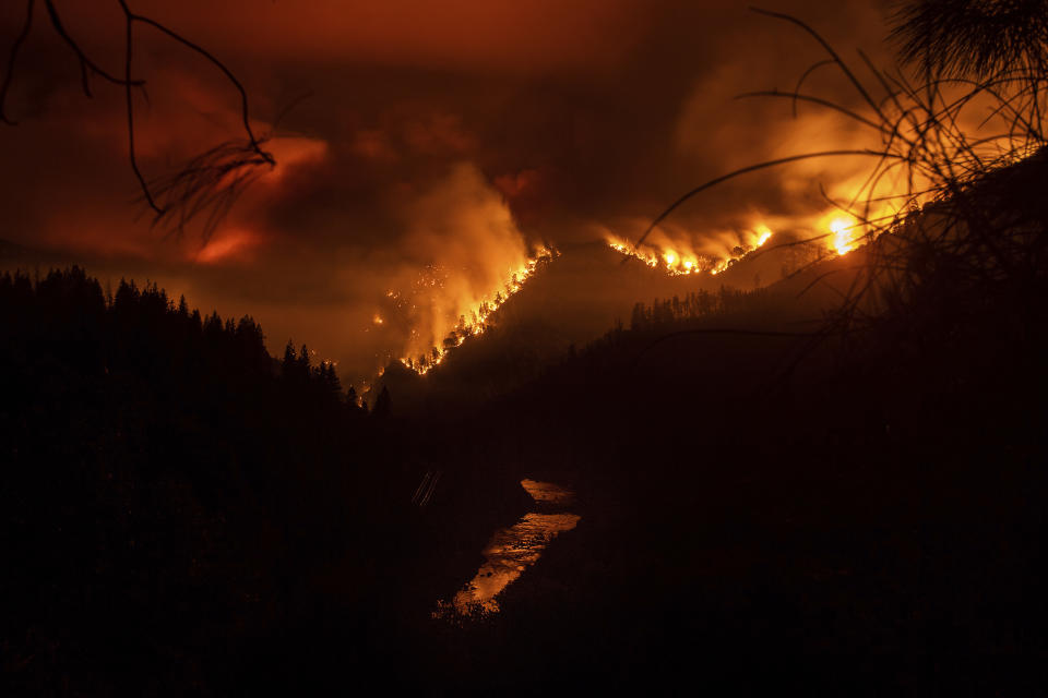 The Delta Fire burns in the Shasta-Trinity National Forest, Calif., on Wednesday, Sept. 5, 2018. Parked trucks lined more than two miles of Interstate 5 as both directions remained closed to traffic. (AP Photo/Noah Berger)