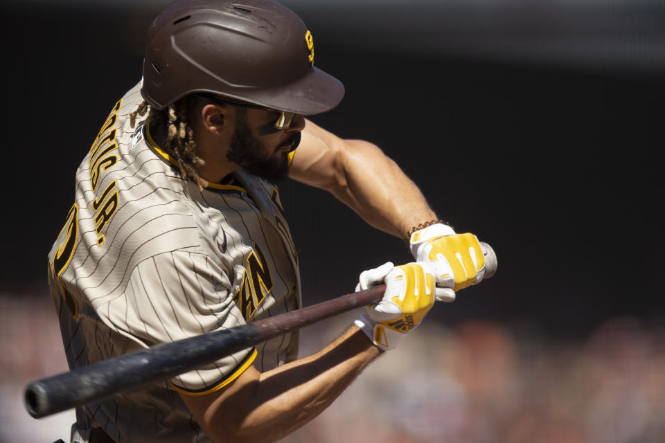 FILE - San Diego Padres' Fernando Tatis Jr. connects for a double against the San Francisco Giants during the fourth inning of a baseball game, Oct. 2, 2021, in San Francisco. Tatis Jr.'s surgically repaired left wrist hasn't progressed to the point where the electrifying All-Star shortstop can start swinging a bat, general manager A.J. Preller said Tuesday, June 14, 2022. (AP Photo/D. Ross Cameron,File)