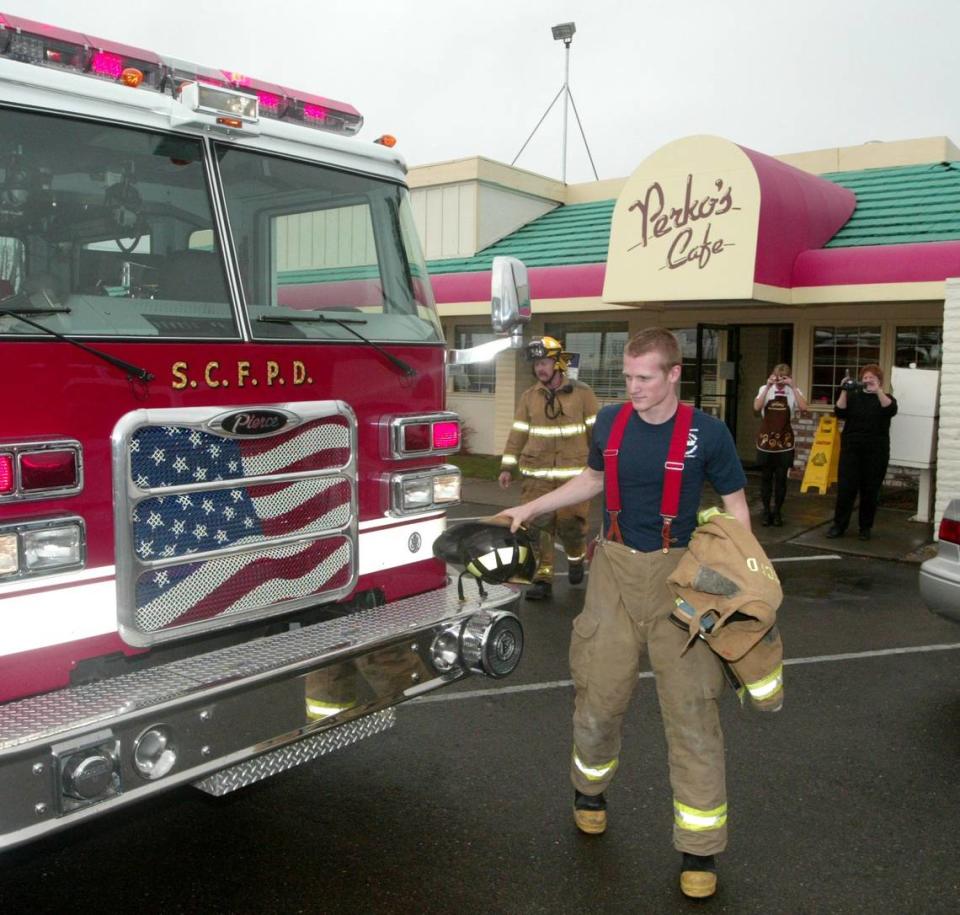 Firefighter Casey Knee walks back to a fire engine after dropping to his knee and proposing to Sarah Ramsey at a Perko’s Cafe on Yosemite Avenue in Modesto in this Modesto Bee file photo from 2005.