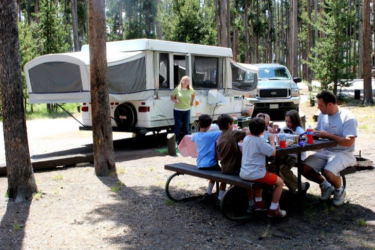 Family picnicking at their site in Grant Village Campground