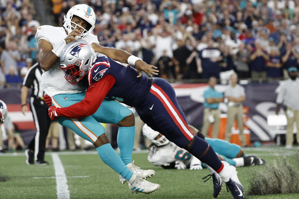 New England Patriots outside linebacker Matt Judon (9) tackles Miami Dolphins quarterback Tua Tagovailoa (1) during the second half of an NFL football game, Sunday, Sept. 12, 2021, in Foxborough, Mass. (AP Photo/Winslow Townson)
