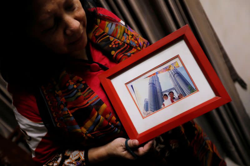 Nina Widyawati, 65-year-old mother of Ratih Purwarini, a doctor who passed away due to the coronavirus disease (COVID-19), shows a photograph of her daughter and grandchildren, at her house in Jakarta