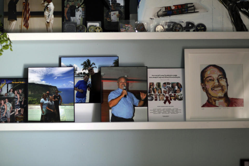 FILE - Memorabilia of Parkland school shooting victim Chris Hixon is displayed at his widow, Debbi Hixon's, home on the second anniversary of his death Friday, Feb. 14, 2020, in Hollywood, Fla. Hixon was one of 17 people killed in a school shooting on Valentine's Day two years earlier at Marjory Stoneman Douglas High School. (AP Photo/Brynn Anderson, File)