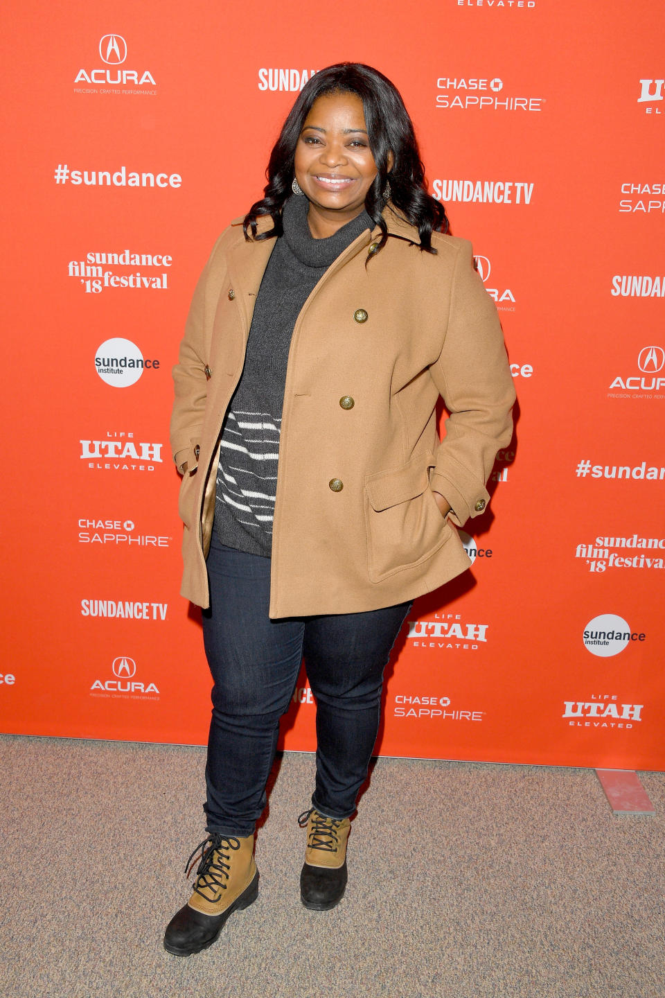 <p>Spencer wears a beige pea coat, a gray turtleneck sweater, blue jeans, and lace-up winter boots at the 2018 Sundance Film Festival in Park City, Utah. (Photo: Getty Images) </p>