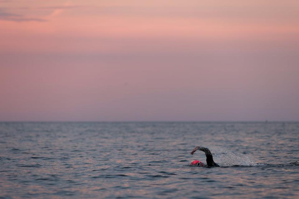 CORK, IRELAND - AUGUST 14: A participant competes in the swim leg of the race during the IRONMAN Ireland, Cork on August 14, 2022 in Cork, Ireland. 