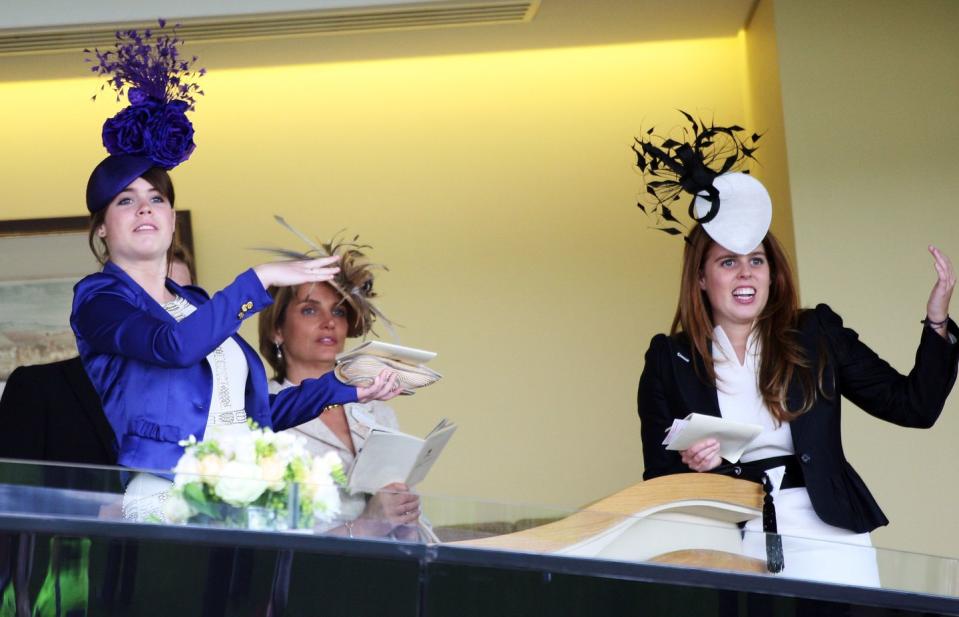 Princess Eugenie and Princess Beatrice dancing.