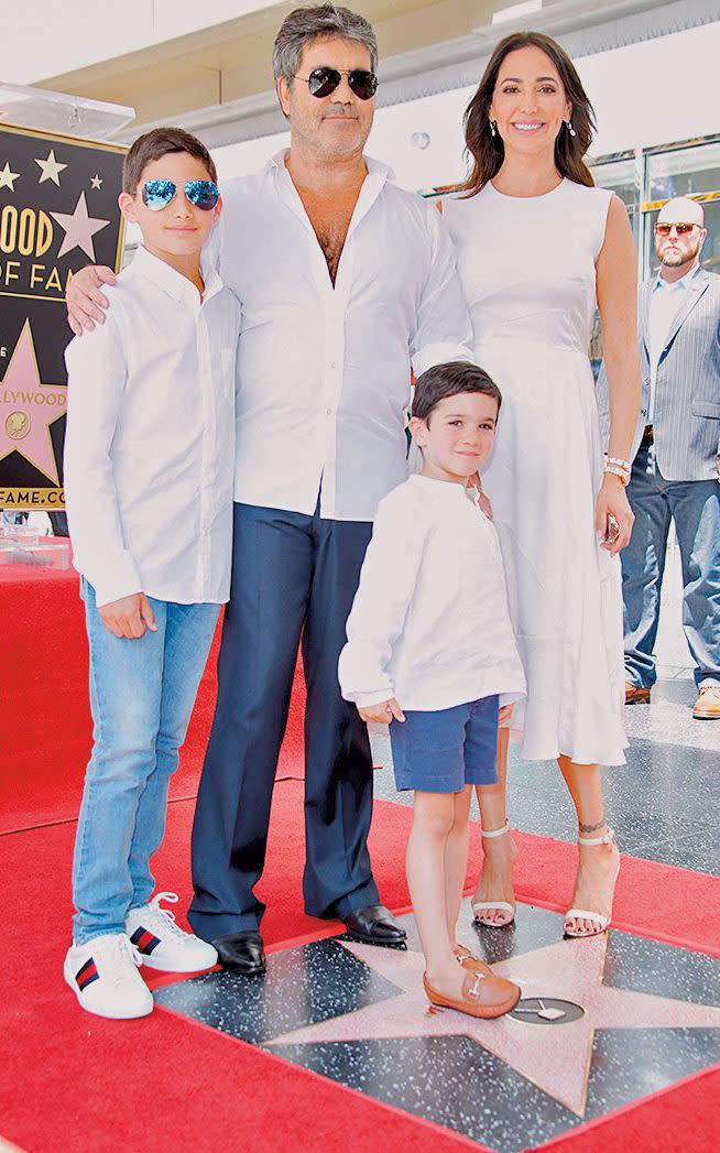 Cowell with Lauren Silverman, her son Adam (left), and Eric - Getty Images 