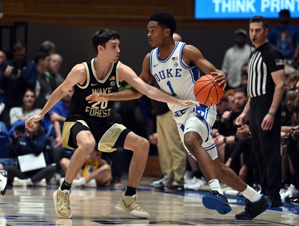 Feb 12, 2024; Durham, North Carolina, USA; Duke Blue Devils guard Caleb Foster (1) controls the ball in front of Wake Forest Deamon Deacons guard Parker Friedrichsen (20) during the first half at Cameron Indoor Stadium. Mandatory Credit: Rob Kinnan-USA TODAY Sports